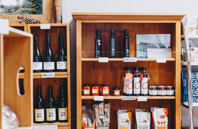 Wine and pantry goods on a shelf in the shop at at Barrys Bay Cheese, Akaroa.