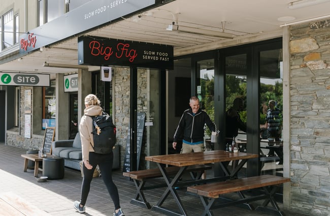 A male customer coming out of Big Fig in Wanaka smiling.