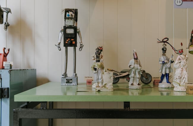 Little handmade robots on a table.