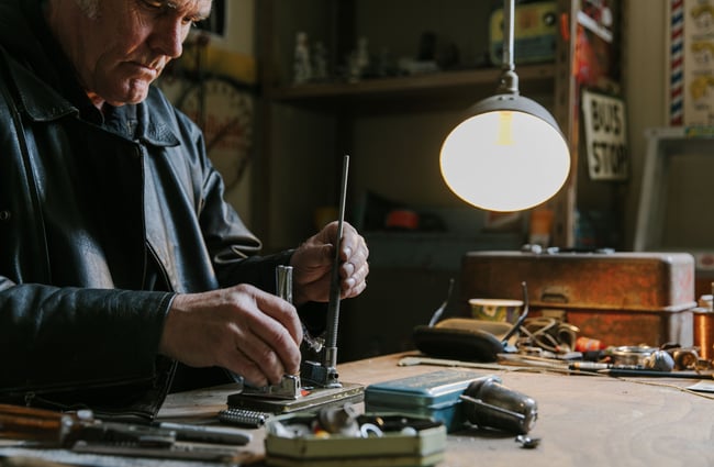 A close up of Martin working at his workshop desk.