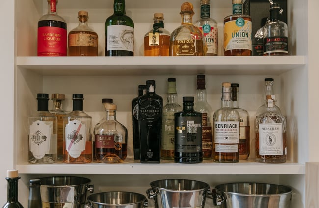 A close up of liquor bottles on a shelf.