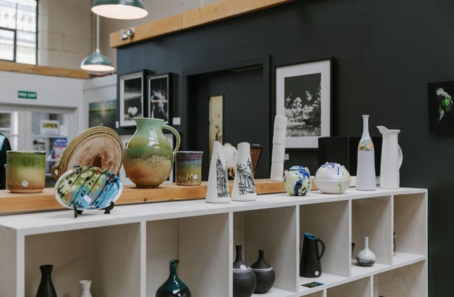 The top of shelves covered in ceramics at CRAFTED in Waitaki.