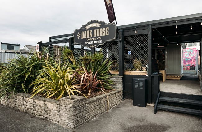 The black and brown exterior and entrance to Dark Horse in Kapiti.
