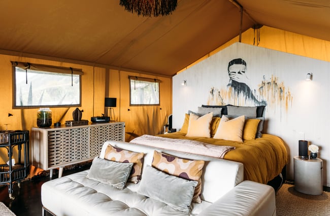 A bedroom inside a glamping tent.