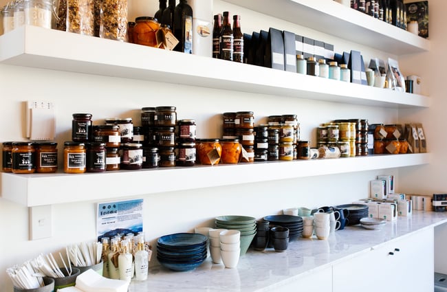 Preserves and ceramics on a shelf.