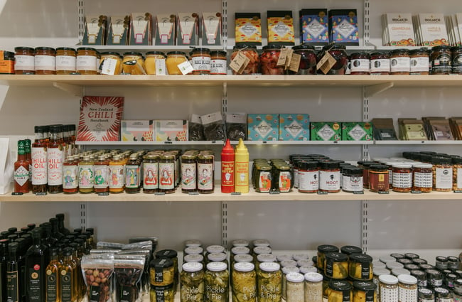 Condiments displayed on shelves.