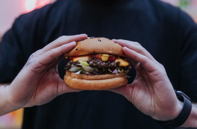 A man holding a burger.