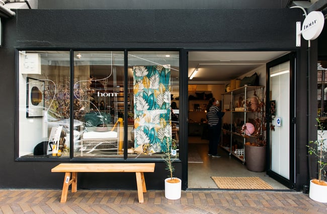 The exterior of Hōm Interiors + Inspiration with the black storefront.