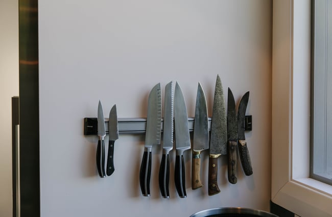 Collection of sharp knives on magnetic strip.