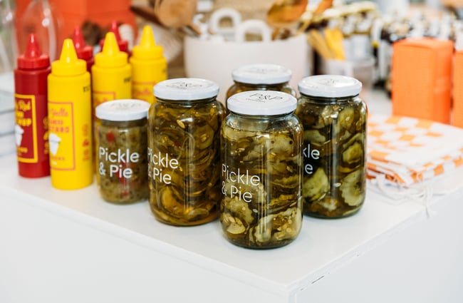 Pickles in jars on a table.
