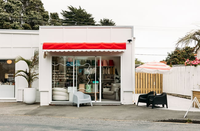 The white and red exterior of a homewares store.
