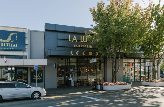 The green exterior of La Luna cafe and restaurant on a sunny day.