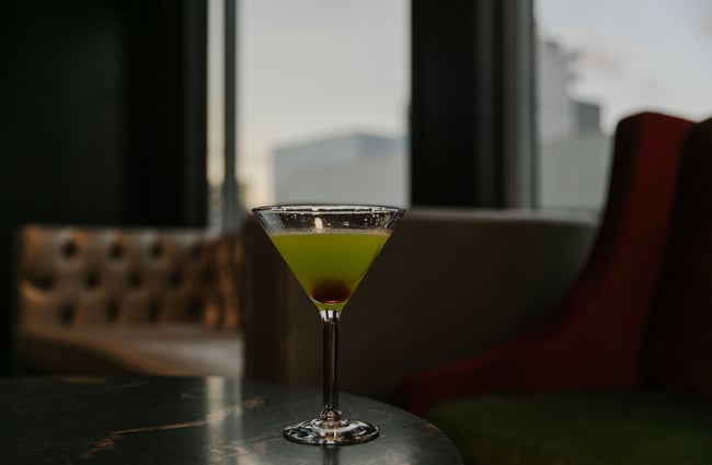 Green cocktail with cherry inside from Level One.