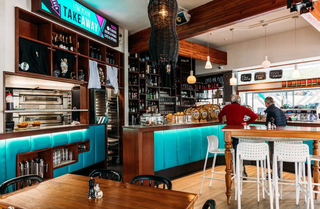 The blue and wooden interior of Long Beach Tavern in Kapiti.
