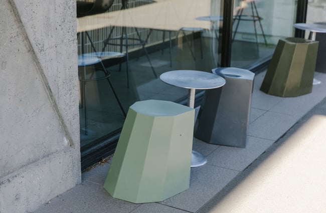 A close up of Arnold Circus stools outside Lux Espresso.