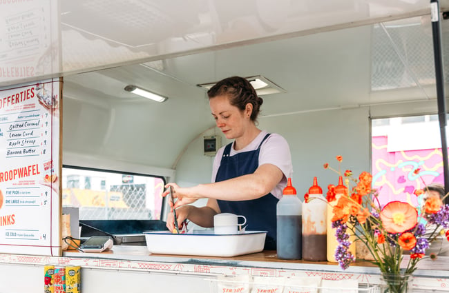 A woman working in a food caravan.