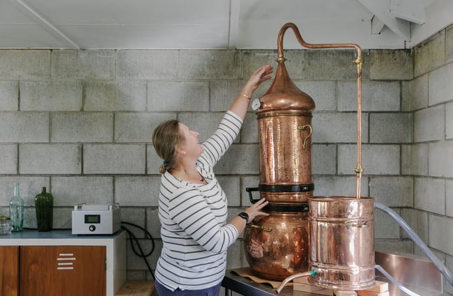 Justine adjusting her distiller at Mt Fyffe Distillery, Kaikōura.