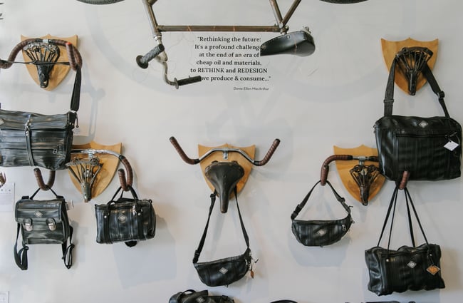 Bike seats used as hooks on a wall inside Revology.