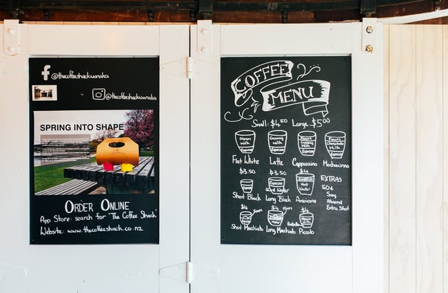 The coffee menu on the roller door.