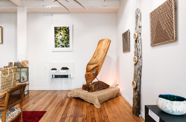 Maori works of art on display inside a gallery.