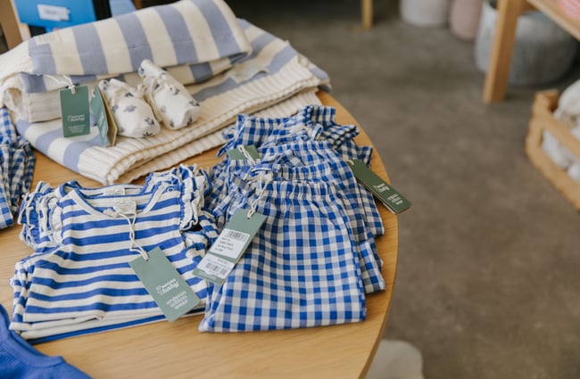 Close up of blue and white checkered baby clothes at William Bee in Ōamaru.