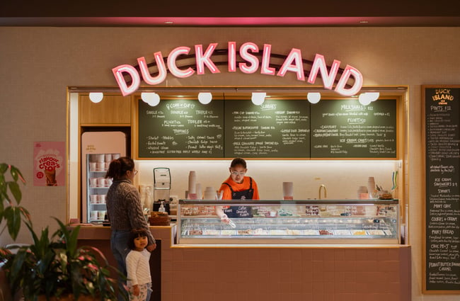 A customer being served at Duck Island Ice Cream inside Willis Lane.