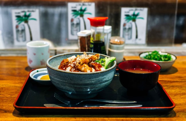 A Japanese bowl and miso soup on a counter.