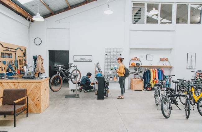 A woman waiting for her bike to be repaired at Action Bicycle Club in Christchurch.