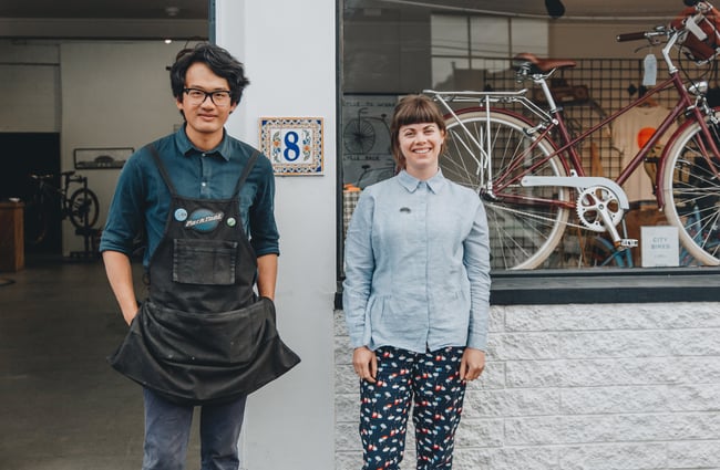 Ken and Charlotte standing outside their store at Action Bicycle Club in Christchurch.