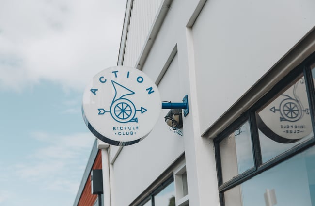 Outdoor signage on the wall of the Action Bicycle Club building in Christchurch.