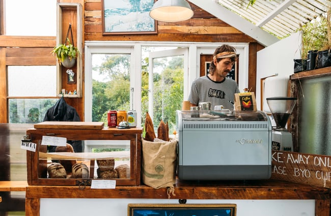 A staff member working behind the counter in the Bacca Bakery cafe.