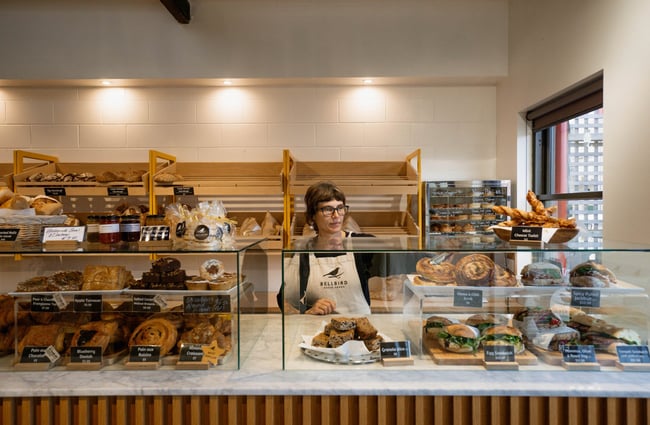 A woman working behind the counter at Bellbird Bakery in Christchurch.