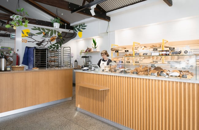 Woman working at the till at Bellbird Bakery in Christchurch.