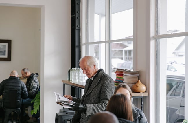 Man reading a magazine at Bobby Franks.