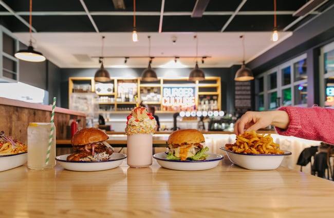 Burgers and fries on a table at Burger Culture.