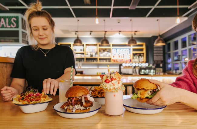 Woman about to eat a burger at Burger Culture.