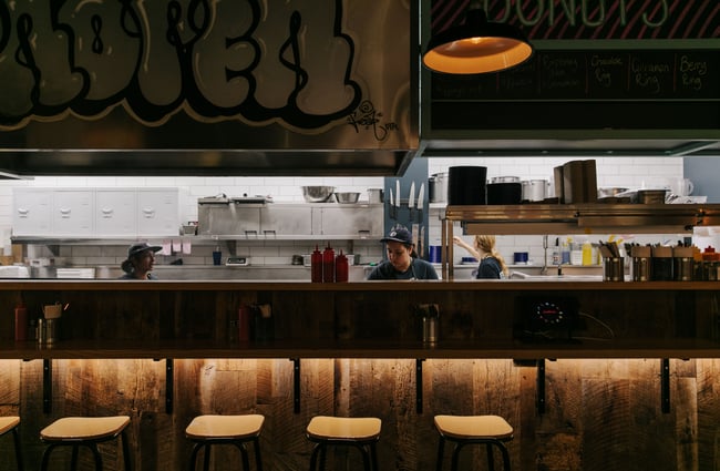 Woman working in the kitchen at Burger Culture.