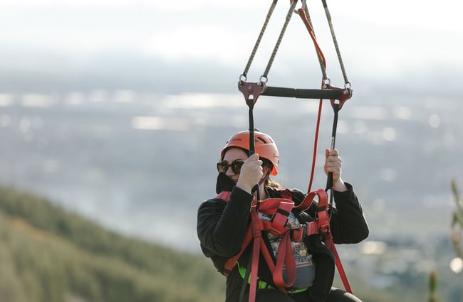 A person harnessed in and waiting to go down one of the zip lines at Christchurch Adventure Park.