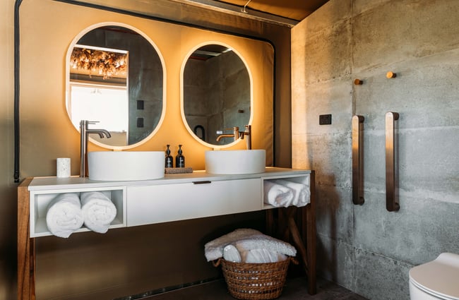 A couples bathroom with matching sink and mirrors.