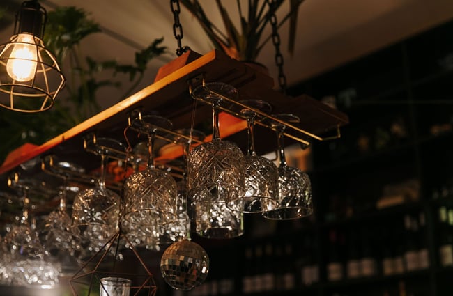 Wine glasses stacked above the bar at East St Cafe and Bar.