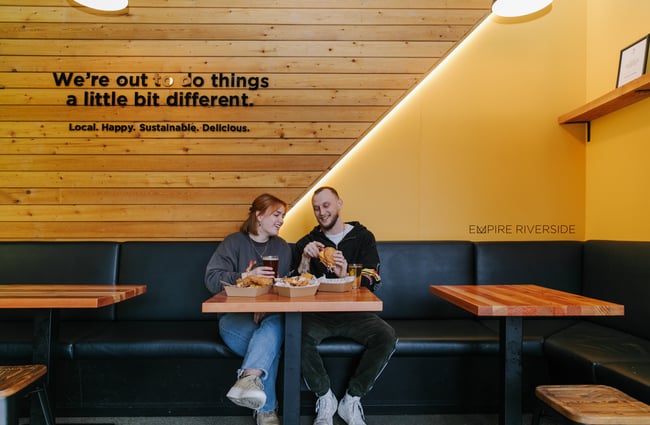 Man and woman enjoying meal at Empire Chicken in Christchurch.