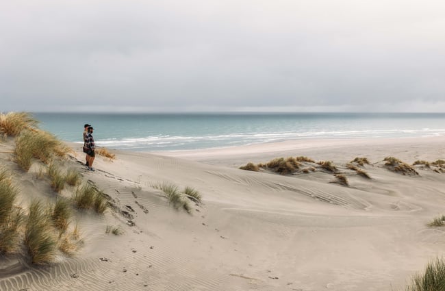 Two men looking out towards the ocean.