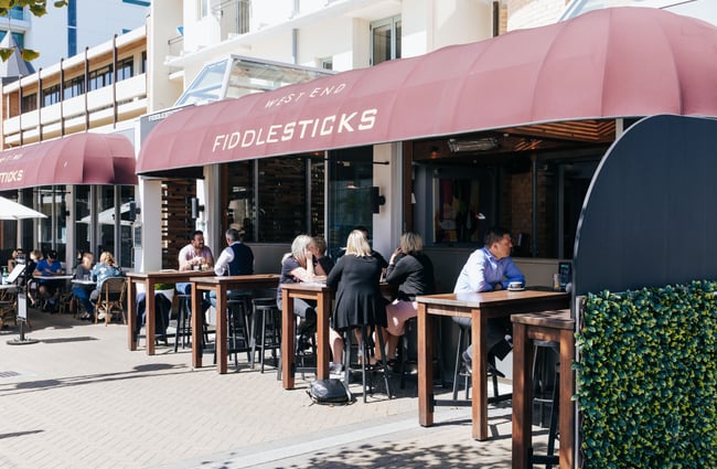 People dining al fresco out front of Fiddlesticks.