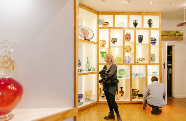 Woman looking around the gallery at flamedaisy.