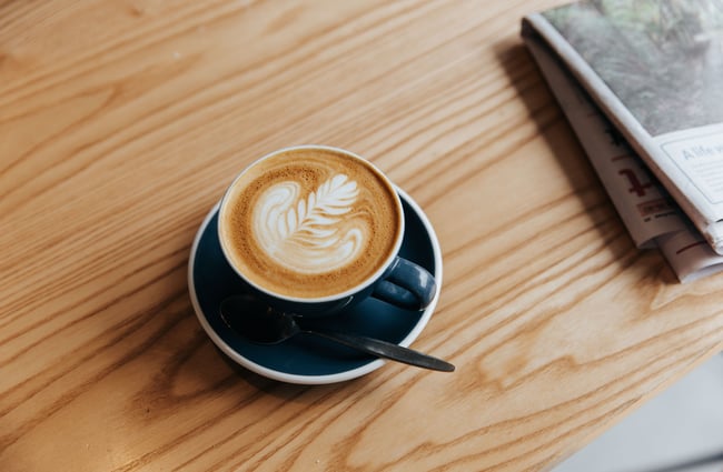 Flat white on a wooden table at Foundation Café in Christchurch.