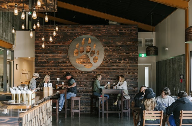 Dining area with customers drinking and eating at Golden Bear Brewing Company, Māpua Tasman.