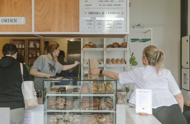 Staff working at the cafe counter inside Grizzly Baked Goods.