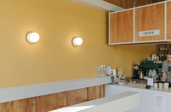 A yellow wall inside a cafe.