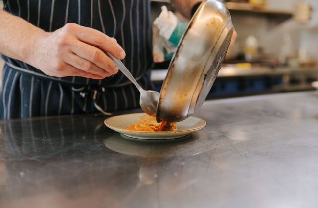 Chef preparing a dish at Hardy St Eatery.