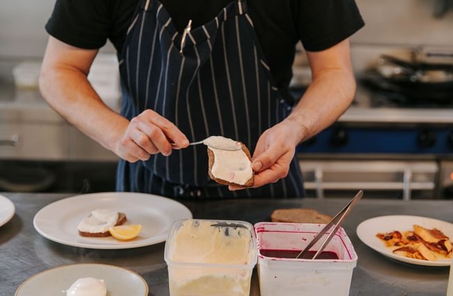 Chef preparing food in the kitchen at Hardy St Eatery.